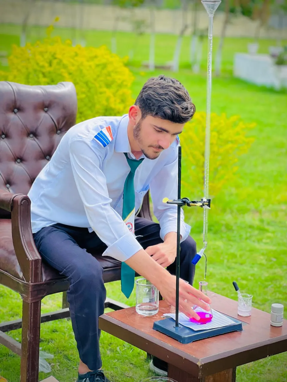 A student taking notes during a biology lab.